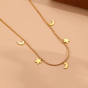 Macro view showing the texture of gold stainless steel snake chain with star and moon charms