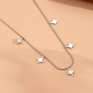 Detailed view of silver stainless steel snake chain necklace with star-shaped pendants