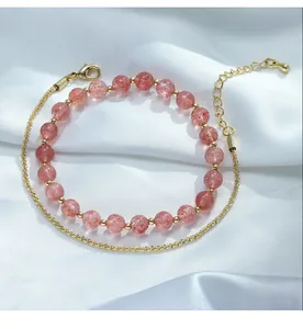 Close-up of double-layer bracelet with natural strawberry quartz and 14K gold-filled chain.