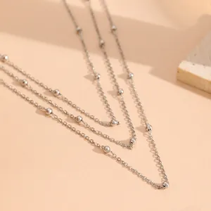 Close-up view of a silver-toned multi-layer beaded chain necklace
