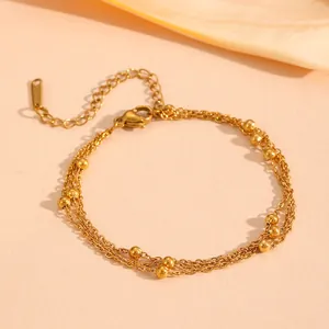 Close-up detail view of a gold three-layer titanium steel beaded chain bracelet.