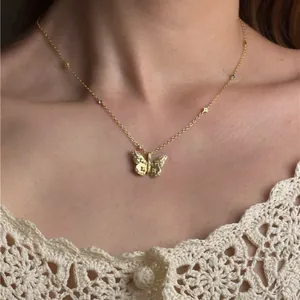 Detailansicht einer eleganten goldenen Schmetterlingshalskette mit Zirkonia am Modell