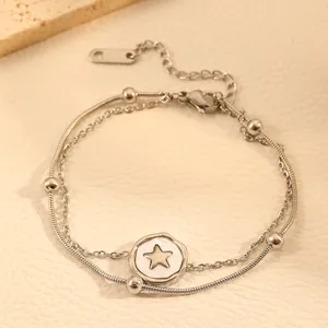 Close-up of double-layer titanium steel anklet featuring a silver star pendant detail.