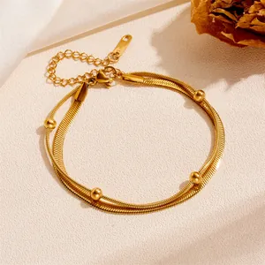 Elegant golden double-layer stainless steel snake chain anklet with small bead accents.