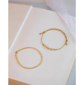 Close-up of yellow citrine and golden rutilated quartz bead bracelets with 14k gold accents