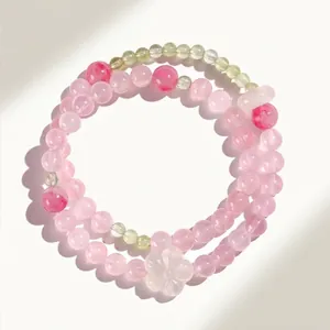Elegante bracciale a doppio giro con perline di cristallo rosa e fiore di agata bianca.