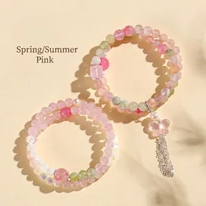 Bracciale a doppio filo in cristallo rosa e agata bianca con nappa a farfalla