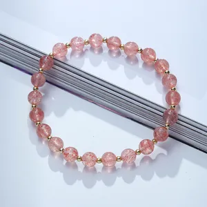Natural strawberry quartz bead bracelet with 14K gold filled spacers on white background