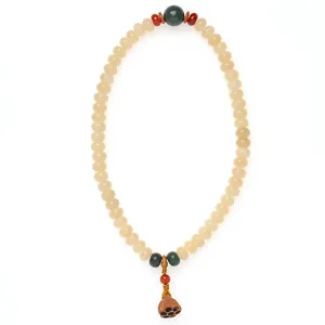 Traditionelles cremegelbes Bodhi-Wurzel Perlenarmband mit Lotussamenkapsel-Anhänger.