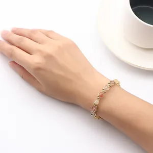 Handmade natural rutilated quartz crystal beaded bracelet worn on a woman's wrist.