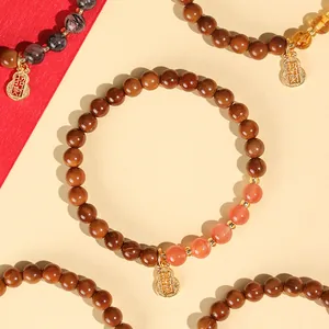 Natur Kuk Holzperlenarmband mit goldenem Reichtum-Kürbis-Anhänger für Damen