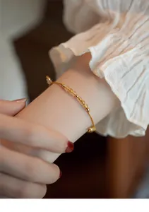 Close-up of citrine and golden rutilated quartz bracelet with 14k gold beads