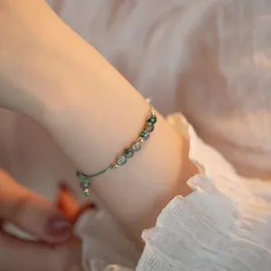 Elegante pulsera de ágata musgosa y cuentas de oro de 14 quilates en la muñeca
