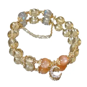 Elegante armband van citrien, maansteen en zonnesteen met goudkleurige maanbedel.