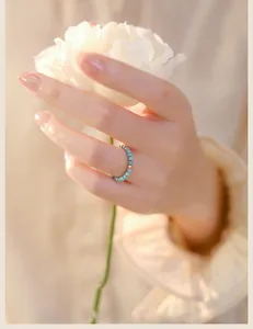 Detailed close-up of an ultra-fine 2mm turquoise beaded ring with a gold bead
