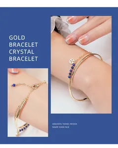 Detail shot of gold-plated bracelet with blue crystal beads and coin charm