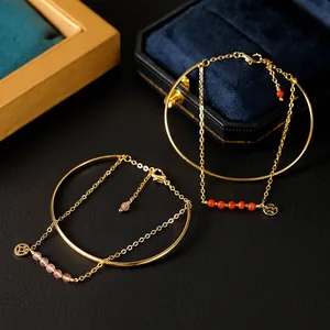 Exquisite gold plated bracelets featuring natural pink and red crystals with lucky coin charms