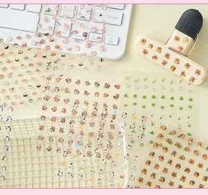Detailed close-up view of various cute mini animal and food decorative stickers for journaling