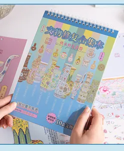 Hands holding a Chinese antique porcelain themed DIY sticker restoration notebook