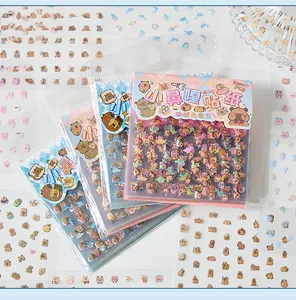 Detailed view of cute capybara PET sticker packs alongside loose decorative sticker sheets