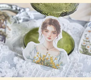 Detail shot of a vintage girl illustration sticker with yellow flowers for DIY journaling