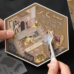 DIY pixel art miniature Egyptian tomb scene sticker set being applied with tweezers