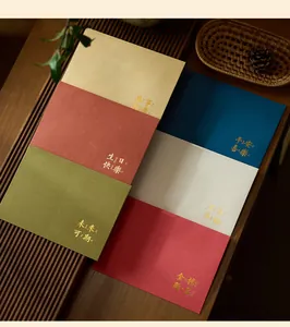 Elegant gold-stamped colorful literary envelopes neatly arranged on a wooden table