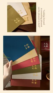 Close-up of elegant gold foil stamped blessing text on colorful vintage envelopes