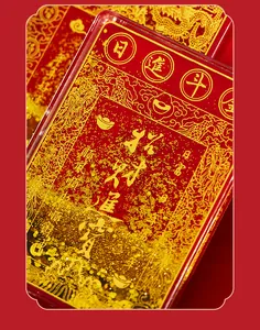 Macro detail of red acrylic quicksand magnet featuring golden Chinese wealth symbols