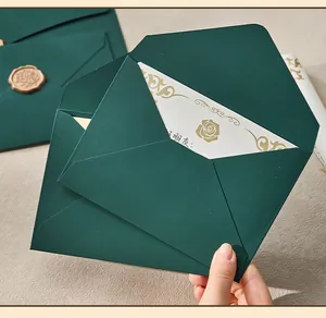 Detailed view of premium dark green envelope and matching card with gold rose pattern