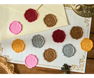 Detail of vintage embossed wax seal stickers in multiple colors for invitations