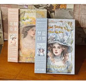 Close-up of vintage European style scrapbooking paper booklets with portrait designs.