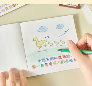 Close-up of a cute mini coloring book featuring adorable duckling illustrations for DIY art.