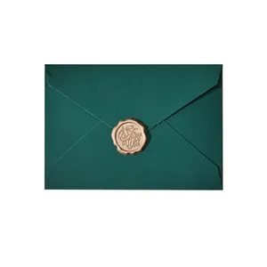 Elegant dark green envelope with a vintage gold wax seal for invitations.