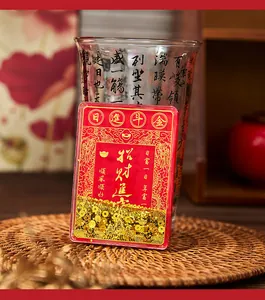 Close-up view of red Chinese quicksand fridge magnet with gold glitter lucky text