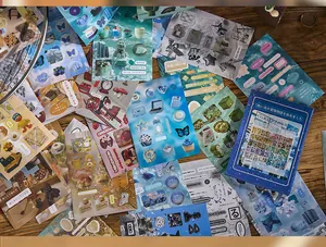 Detailed view of various vintage-style die-cut sticker sheets on a wooden table.
