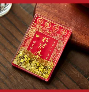 Close-up of red quicksand refrigerator magnet with gold auspicious Chinese calligraphy