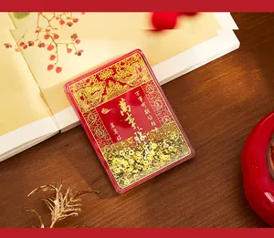 Close-up of acrylic quicksand refrigerator magnet with traditional gold dragon design
