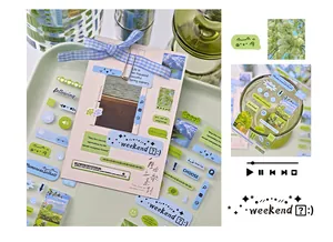 Close-up of clear synthetic stickers with nature scenes and aesthetic quotes for journaling