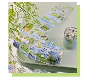 Close-up of green theme PET tape with landscape and flower patterns for scrapbooking diy