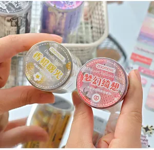 Macro view of decorative die-cut washi tape rolls featuring orange and strawberry themes