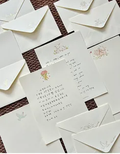 Elegant cream stationery set featuring gold-foiled illustrations and handwritten style text.