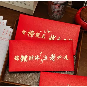 Detailed shot of red envelopes with gold foil motivational calligraphy for students