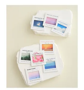 Close-up detail of PET slide film keychains featuring nature scenery and healing quotes