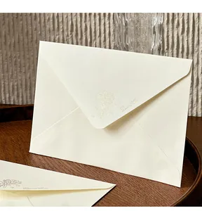 Close-up of elegant cream-colored envelope with floral embossing and Eternal Bloom text