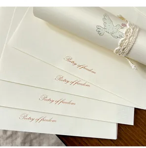 Detailed view of cream stationery featuring 'Poetry of freedom' text and dove illustration