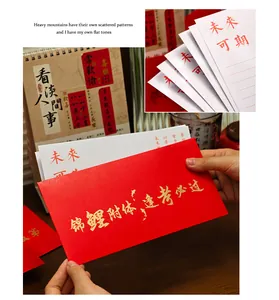 Close-up of red envelope with gold calligraphy and matching letter paper