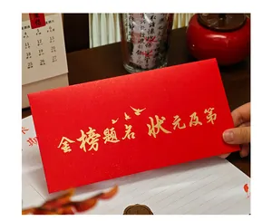 Detailed macro view of a red graduation envelope with gold embossed calligraphy.