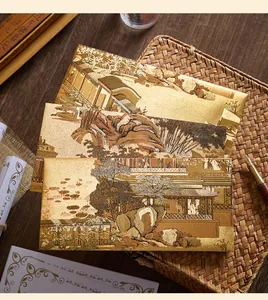 Close-up of golden Chinese style envelopes with traditional art illustrations.