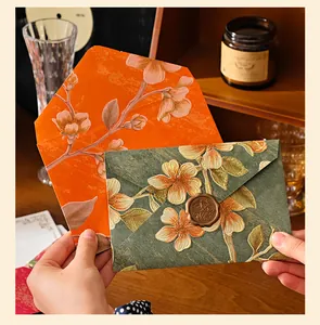 Close-up view of vintage embossed floral envelopes with decorative wax seal for invitations